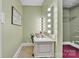 Bright vanity area features a lighted makeup mirror and leads to a walk-in closet with built-in shelving at 528 1St Nw Ave, Hickory, NC 28601