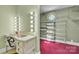 Bright vanity area features a lighted makeup mirror and leads to a walk-in closet with built-in shelving at 528 1St Nw Ave, Hickory, NC 28601