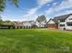 Large backyard features lush green lawn, privacy fencing, and manicured landscaping at 5511 Fairview Rd, Charlotte, NC 28209