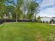 Expansive backyard featuring lush green grass, privacy fencing, and meticulous landscaping at 5511 Fairview Rd, Charlotte, NC 28209