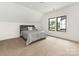 Bedroom with neutral carpet, white walls, and a gray upholstered bed near the windows at 5511 Fairview Rd, Charlotte, NC 28209