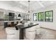 Bright dining room features a coffered ceiling, hardwood floors, modern chandelier and view of kitchen at 5511 Fairview Rd, Charlotte, NC 28209