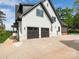 Stunning home exterior boasts a two-car garage, white siding, and black trim for a modern look at 5511 Fairview Rd, Charlotte, NC 28209