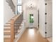 Bright foyer with hardwood floors, staircase, chandelier, and an inviting front door at 5511 Fairview Rd, Charlotte, NC 28209