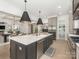 Spacious kitchen with a large island, stainless steel appliances, and open layout to the living area at 5511 Fairview Rd, Charlotte, NC 28209