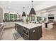 Modern kitchen featuring a large island, stainless steel appliances, and an open concept layout at 5511 Fairview Rd, Charlotte, NC 28209