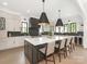 Modern kitchen with a large island, pendant lighting, stainless steel appliances, and custom cabinetry at 5511 Fairview Rd, Charlotte, NC 28209