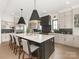 Gorgeous kitchen featuring a large island, stainless steel appliances, custom cabinets, and hardwood flooring at 5511 Fairview Rd, Charlotte, NC 28209
