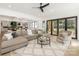 Open living room with modern ceiling fan, hardwood floors and sliding doors to the outdoor living space at 5511 Fairview Rd, Charlotte, NC 28209