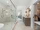 Modern bathroom features a walk-in shower with a glass door and a view into the main bedroom at 5511 Fairview Rd, Charlotte, NC 28209
