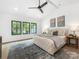Main bedroom with bright natural light, hardwood floors, neutral decor, and a modern ceiling fan at 5511 Fairview Rd, Charlotte, NC 28209