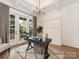Home office with a modern desk, neutral rug, and French doors that lead to a balcony at 5511 Fairview Rd, Charlotte, NC 28209