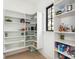 Well-organized pantry with ample shelving and natural light from a window at 5511 Fairview Rd, Charlotte, NC 28209