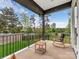 Relaxing porch with a rocking chair overlooking a beautifully landscaped front yard and quiet street at 5511 Fairview Rd, Charlotte, NC 28209