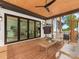 Relaxing screened porch with wood ceiling, fan, wood floors, and comfortable seating for enjoying the outdoors at 5511 Fairview Rd, Charlotte, NC 28209