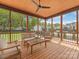 Inviting screened-in porch with comfortable seating and views of the backyard and pool area at 5511 Fairview Rd, Charlotte, NC 28209