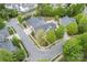 An aerial view of the home showing the roof, garages, landscaping, and surrounding homes at 6311 Ridge Path Ln, Charlotte, NC 28269