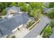 An aerial view of home showing the roof, multiple garages, well manicured landscaping, and adjacent street at 6311 Ridge Path Ln, Charlotte, NC 28269