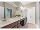 Bathroom with double sinks, a large mirror, vanity cabinets, and access to the shower at 6311 Ridge Path Ln, Charlotte, NC 28269