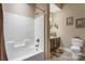 Neutral bathroom featuring shower, toilet, dark wood vanity with mirror and decorative wall art at 6311 Ridge Path Ln, Charlotte, NC 28269