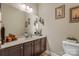 Powder room features an undermount sink, framed mirror, decorative wall art, and tile flooring at 6311 Ridge Path Ln, Charlotte, NC 28269