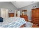 Bedroom with neutral walls, a queen bed, hardwood floors, and multiple doorways at 6311 Ridge Path Ln, Charlotte, NC 28269