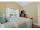 Cozy bedroom with blue comforter, window blinds, and television on top of wooden dresser at 6311 Ridge Path Ln, Charlotte, NC 28269