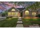 Charming home showcasing a blend of siding and stone finishes, enhanced by a beautifully landscaped front yard at 6311 Ridge Path Ln, Charlotte, NC 28269