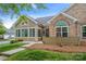 Inviting home with siding and stone details, featuring a neatly arranged landscape and clear pathway at 6311 Ridge Path Ln, Charlotte, NC 28269