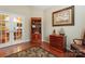 Home office features hardwood floors, glass paneled doors, a book case, and a ship model at 6311 Ridge Path Ln, Charlotte, NC 28269