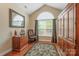 Home office boasts hardwood floors, a desk, an office chair, and a large window at 6311 Ridge Path Ln, Charlotte, NC 28269