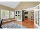 Open living space featuring hardwood floors, French doors, and a view into a cozy living room with a fireplace at 6311 Ridge Path Ln, Charlotte, NC 28269