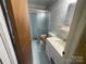 Modest bathroom with a glass door shower and standard sink at 729 Aintree Rd, Charlotte, NC 28215