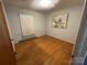 Bedroom with hardwood floors, light-colored walls, radiator, and large windows provides ample natural light at 729 Aintree Rd, Charlotte, NC 28215