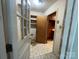View of a home's entryway, showing interior door, closet space, and transition into an additional room at 729 Aintree Rd, Charlotte, NC 28215
