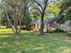 Traditional brick home nestled among mature trees, providing a peaceful and shaded atmosphere in a desirable neighborhood at 729 Aintree Rd, Charlotte, NC 28215