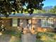 Charming brick home with a welcoming front porch and mature landscaping, creating excellent curb appeal at 729 Aintree Rd, Charlotte, NC 28215