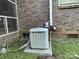Close-up of a Trane XE 1000 HVAC unit installed outside of the brick home on a concrete pad at 729 Aintree Rd, Charlotte, NC 28215