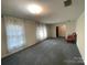 Bright living room features natural light, soft carpeting, and neutral walls, creating a relaxing atmosphere at 729 Aintree Rd, Charlotte, NC 28215