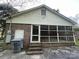 Screened-in porch with access door, offering a seamless blend of indoor and outdoor living and an additional entrance at 729 Aintree Rd, Charlotte, NC 28215