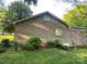 Brick home showcasing architectural details, lush greenery, and a well-maintained exterior, blending charm with functionality at 729 Aintree Rd, Charlotte, NC 28215