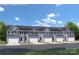 New construction townhome exterior featuring gray siding, white garage doors, and blue front doors at 7349 Childress Sw Dr, Concord, NC 28025