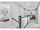 Bright hallway with carpeted stairs leading to a desk area and an open bedroom at 7349 Childress Sw Dr, Concord, NC 28025