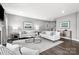Bright living room with hardwood floors, stylish furniture, and a staircase at 7349 Childress Sw Dr, Concord, NC 28025