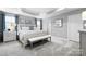 Spacious main bedroom featuring soft carpet, a tray ceiling, and large windows at 7349 Childress Sw Dr, Concord, NC 28025
