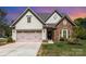 Charming home with stone and siding exterior and a two-car garage at 740 Rosegate Dr, Gastonia, NC 28056