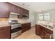 Well-equipped kitchen with stainless steel appliances, dark cabinetry and granite countertops at 740 Rosegate Dr, Gastonia, NC 28056