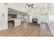 Open-concept living room featuring a fireplace, ceiling fan and hardwood floors at 740 Rosegate Dr, Gastonia, NC 28056