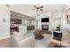 A staged living room featuring a fireplace, ceiling fan and hardwood floors at 740 Rosegate Dr, Gastonia, NC 28056