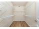 Spacious walk-in closet featuring multiple wire shelves and wood-look flooring at 740 Rosegate Dr, Gastonia, NC 28056